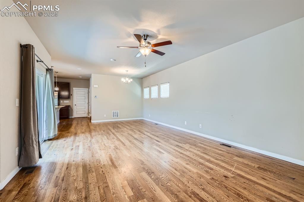 Image 5 of 27: Unfurnished living room featuring ceiling fan, light wood-type flooring, an