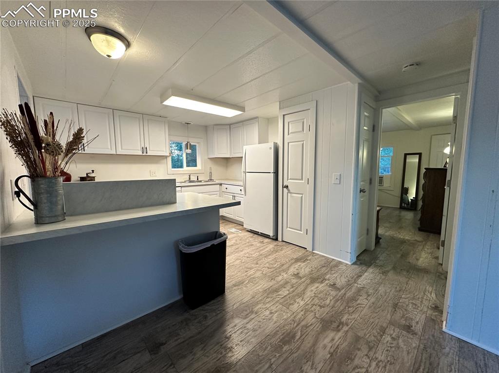 Image 10 of 36: Kitchen & dining area with view into primary bedroom