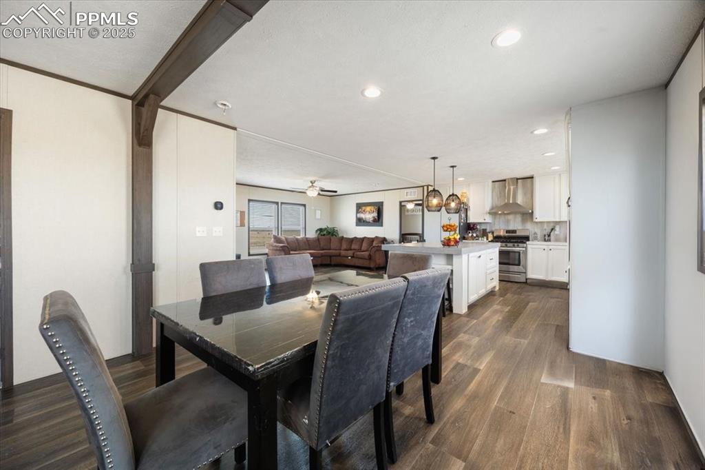 Image 16 of 40: Dining room featuring dark wood-type flooring, a ceiling fan, and recessed 