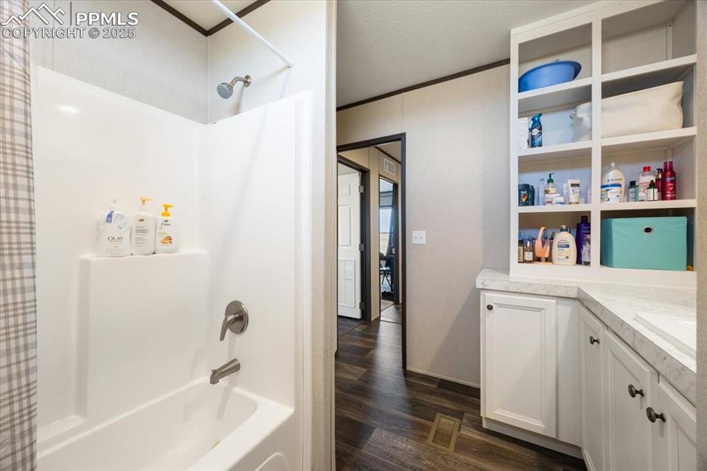 Image 23 of 40: Bathroom with ornamental molding, shower / bath combo with shower curtain, 