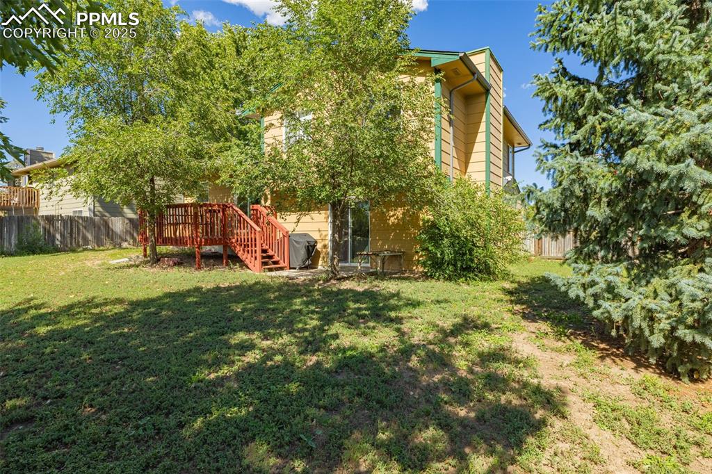 Image 24 of 37: View of yard with stairway and a wooden deck