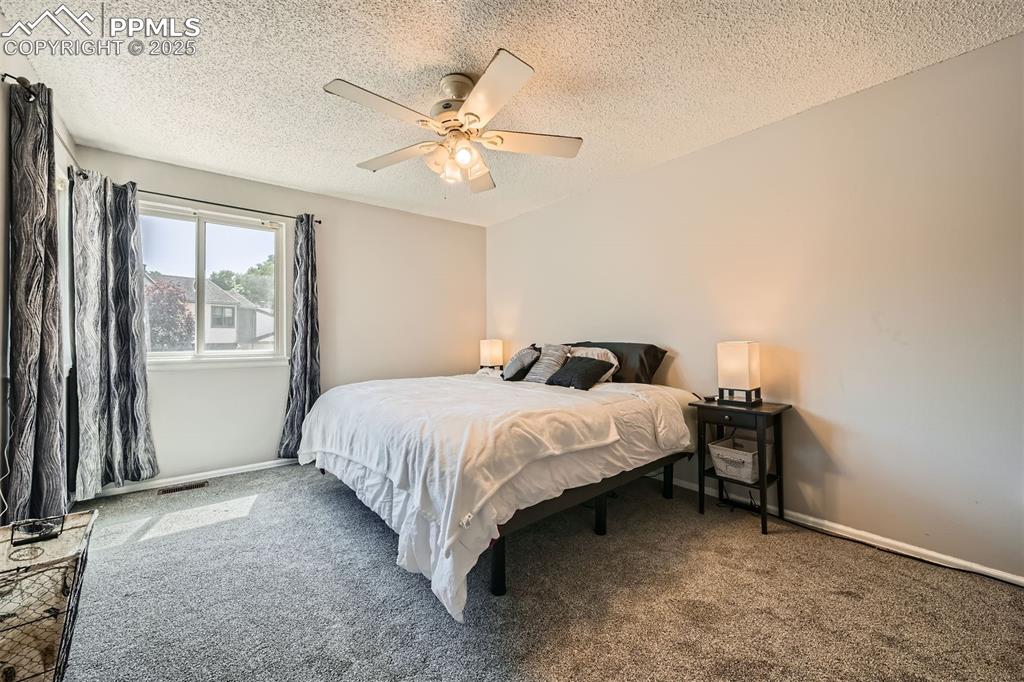 Image 12 of 29: Spacious primary bedroom with plenty of space
