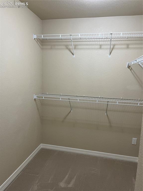 Image 21 of 38: Primary walk in closet