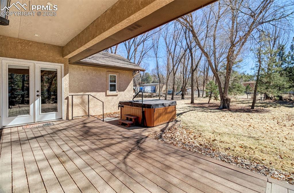 Image 10 of 48: Back deck off the primary bedroom with easy access to the hot tub