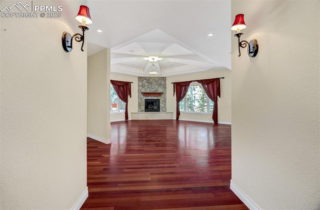 Image 3 of 48: Foyer looking to the living room. Notice the luxurious wood flooring throug
