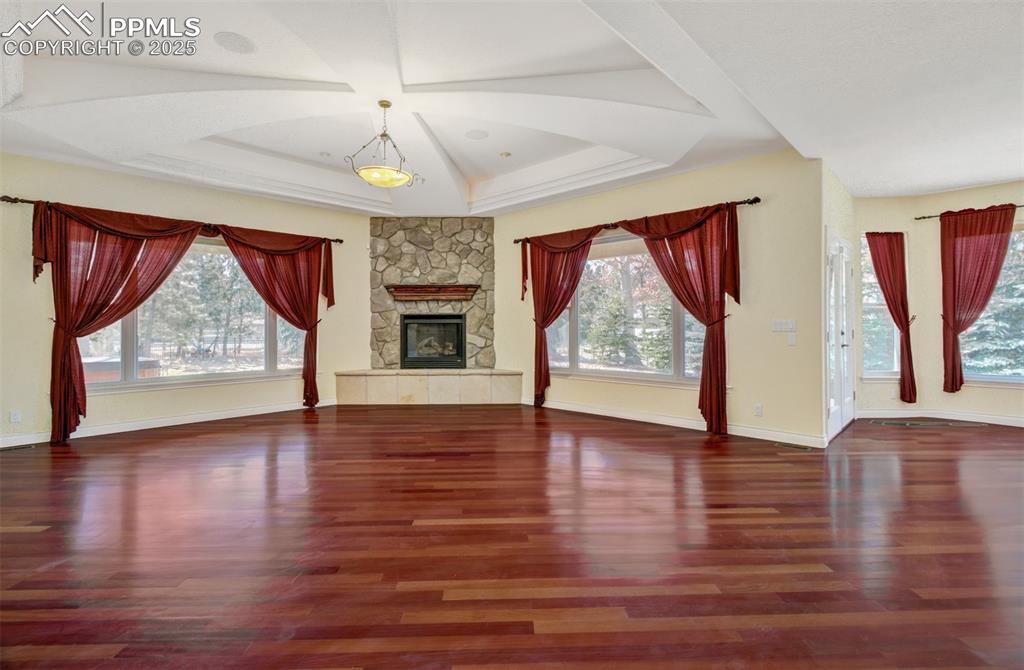 Image 5 of 48: Living room with wood flooring, tons of natural light, custom vaulted ceili
