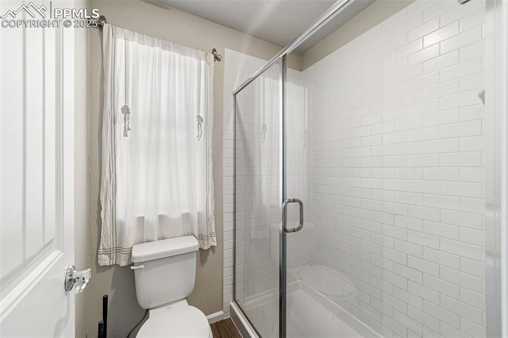 Image 12 of 23: Modern walk-in shower with glass enclosure and premium tile surround.