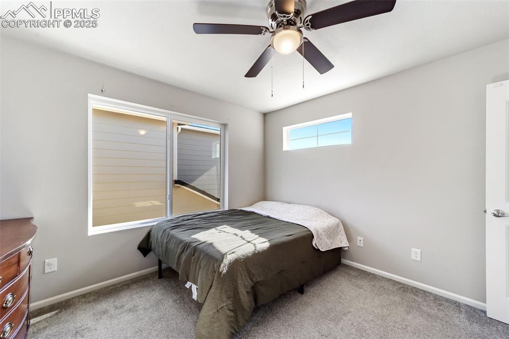 Image 14 of 23: Well-appointed guest bedroom with neutral tones and ample closet space.