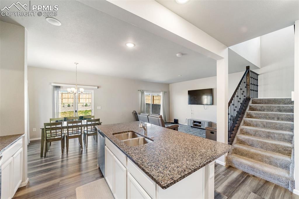 Image 2 of 23: Open-concept kitchen with a large granite island, stainless steel appliance