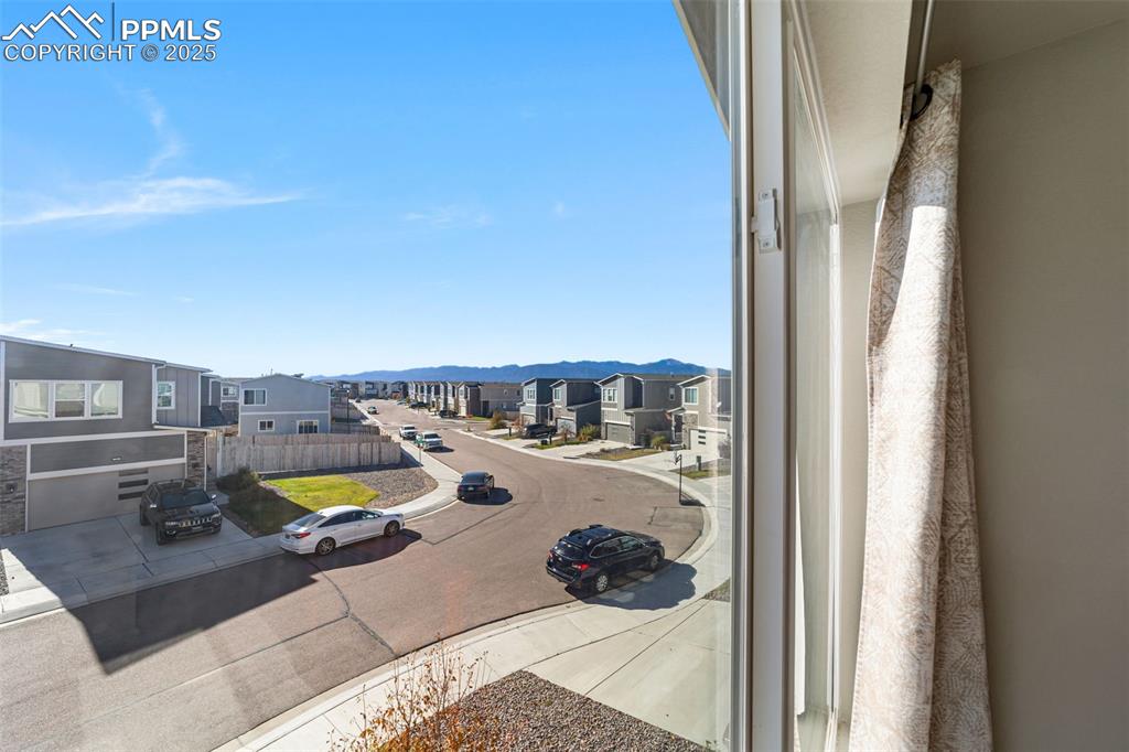 Image 21 of 23: Enjoy outdoor living and mountain views from the upper level bedroom