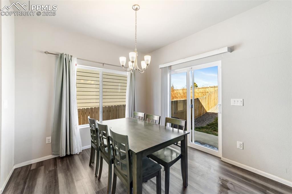 Image 4 of 23: Open dining area with elegant lighting and access to the backyard walk-out.