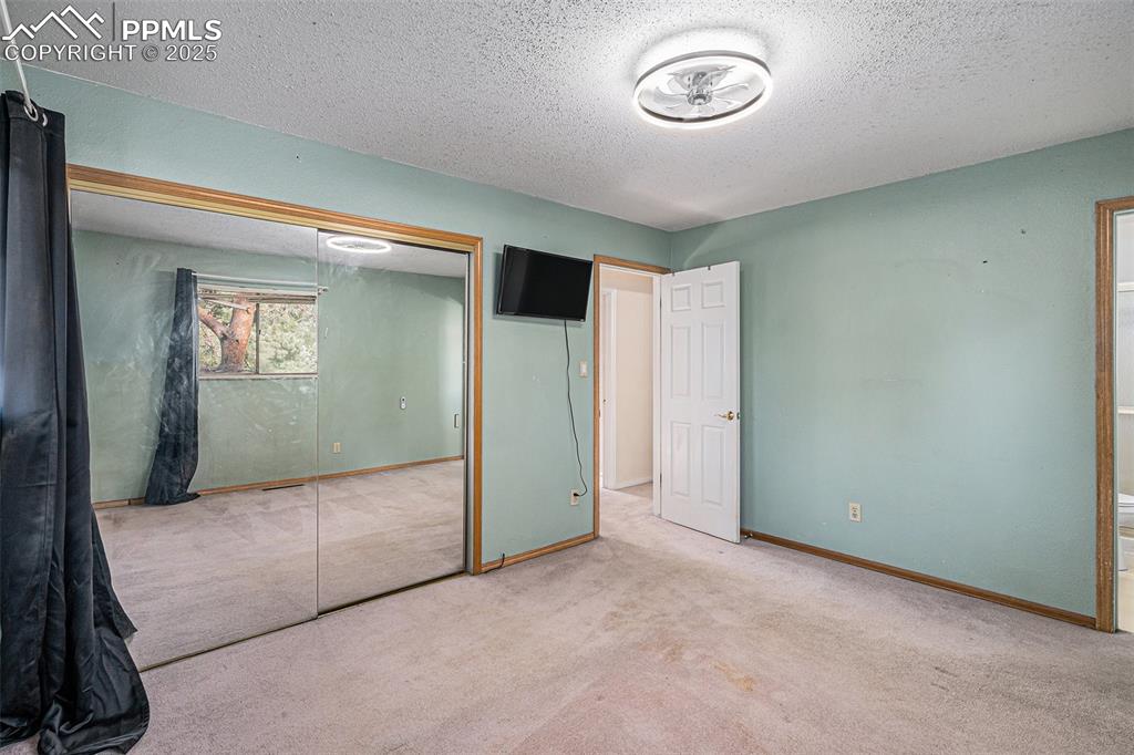 Image 11 of 20: Primary Bedroom with Double Mirror Closet Doors!