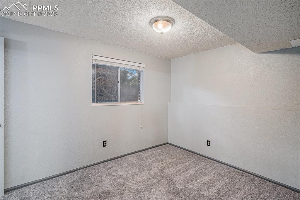 Image 16 of 20: Lower Level Bedroom with Adjoining Bathroom