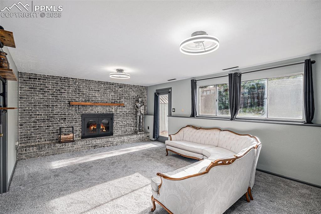 Image 5 of 20: Gorgeous Lower Level Family Room with New Carpet and Brick Fireplace. Walko