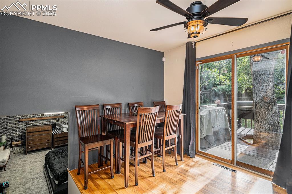 Image 9 of 20: Off Kitchen Dining area with Hardwood Floors and Walkout to the Backyard De