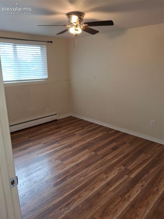 Image 10 of 10: Wood-finish flooring, ceiling fan with integrated lighting, and window with