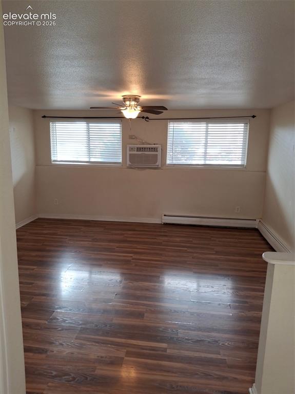 Image 9 of 10: Wood-finish flooring throughout, two windows with horizontal blinds, ceilin