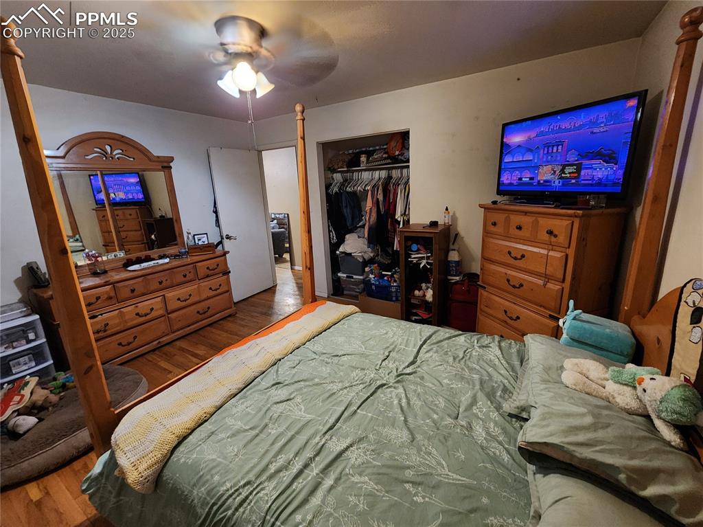 Image 16 of 33: Bedroom #1 featuring wood finished floors, a ceiling fan, and a closet