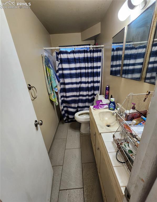 Image 24 of 33: Bathroom #2 with vanity and light tile floors