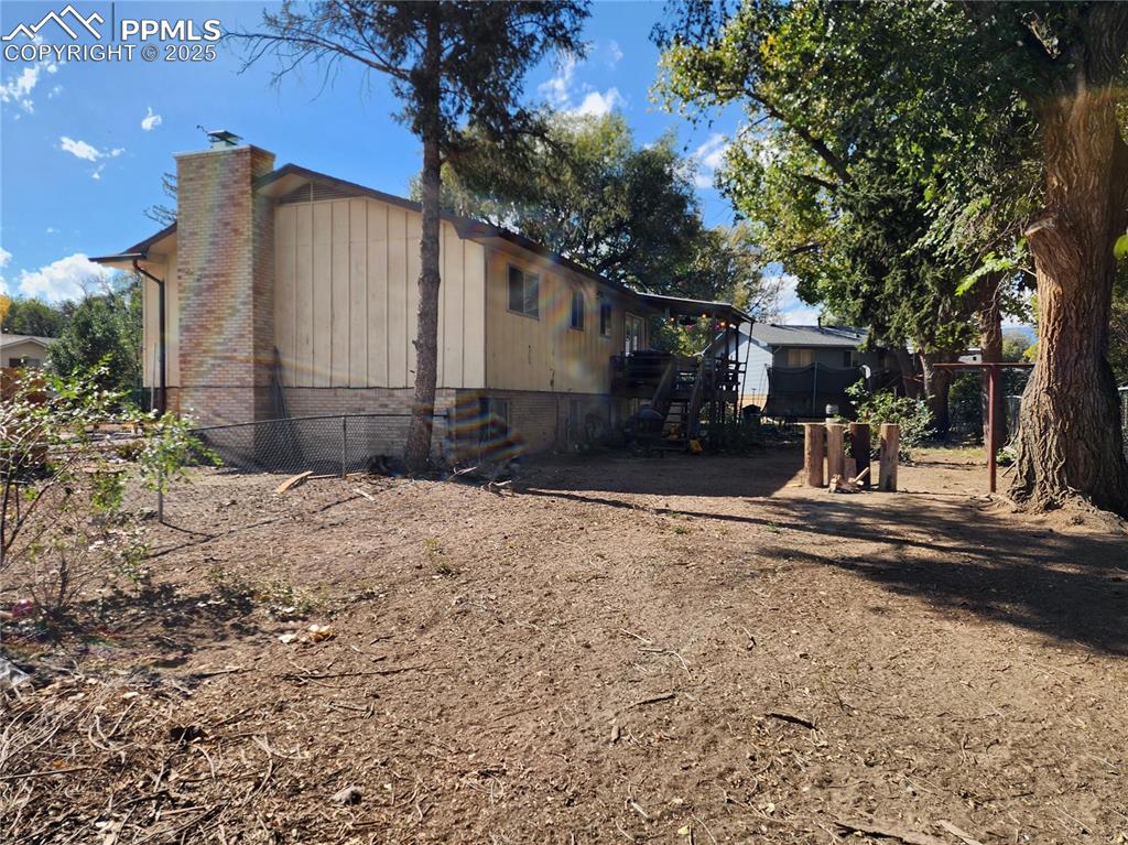Image 4 of 33: View of property exterior featuring a chimney