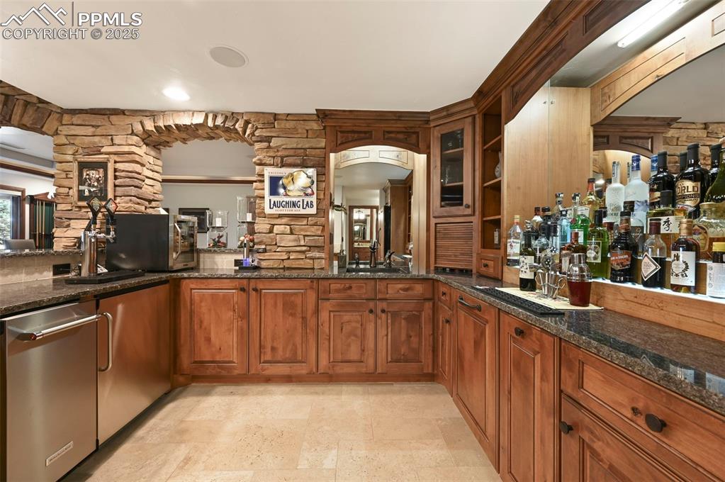 Image 27 of 50: Amazing bar with kegerator, dishwasher, and small refrigerator