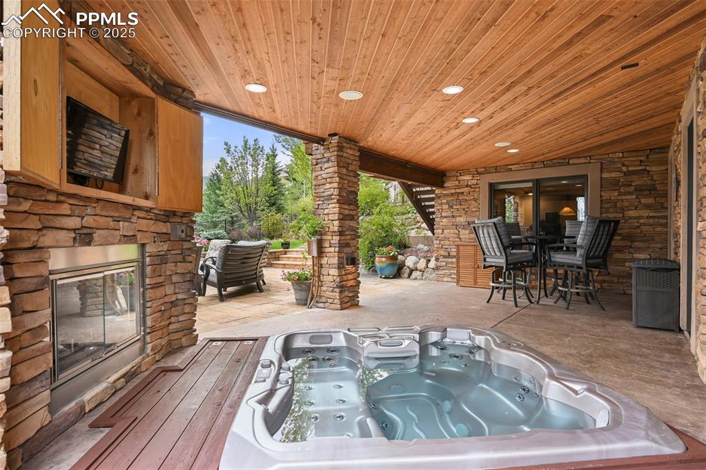 Image 37 of 50: Lower level spa and fireplace