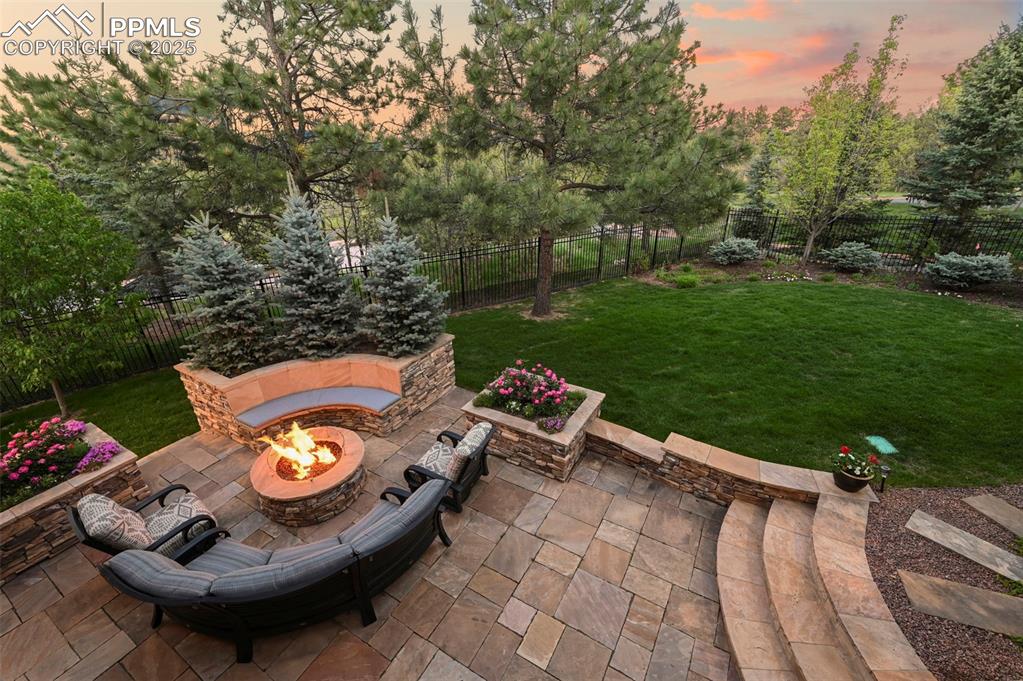 Image 40 of 50: Amazing outdoor patio with gas firepit and seating.