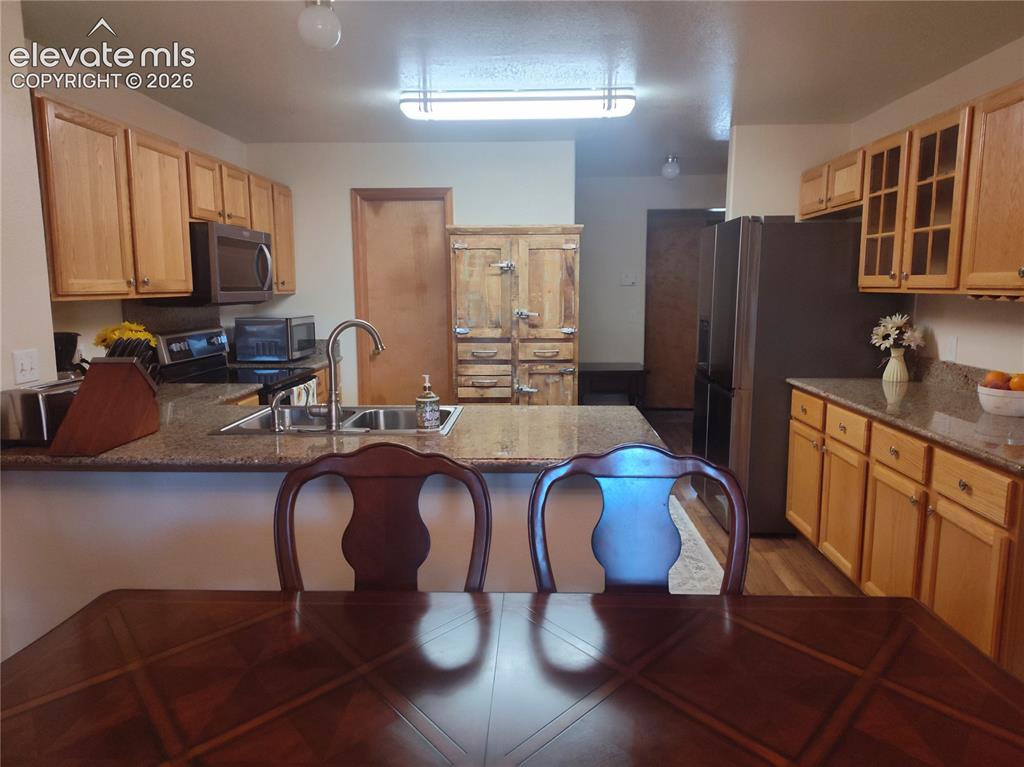 Image 12 of 49: Kitchen w/ stainless steel appliances