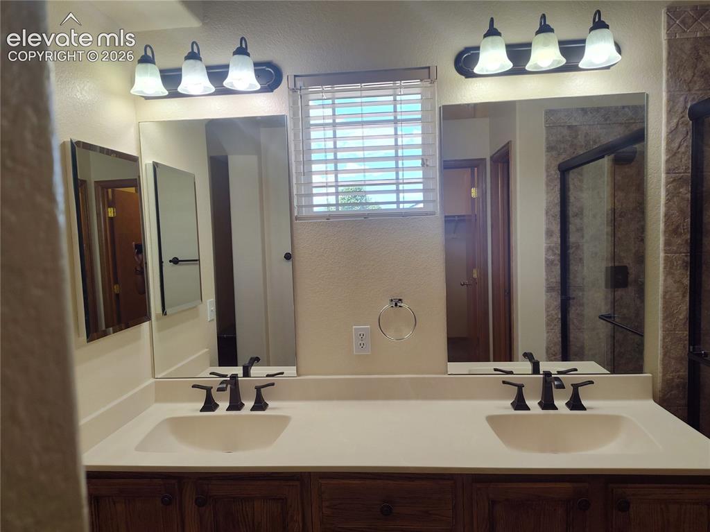 Image 27 of 49: primary bathroom w/double vannities