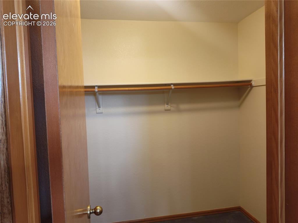 Image 28 of 49: Walk-in closet in primary bedroom