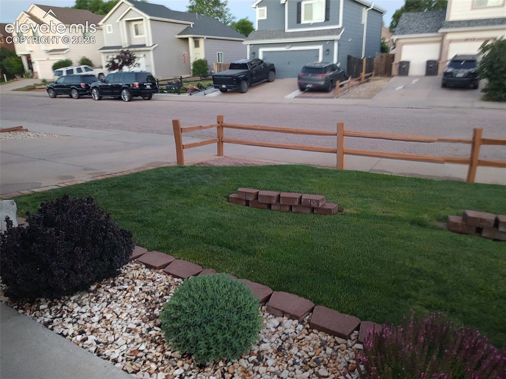 Image 3 of 49: Beautiful front yard landscaping