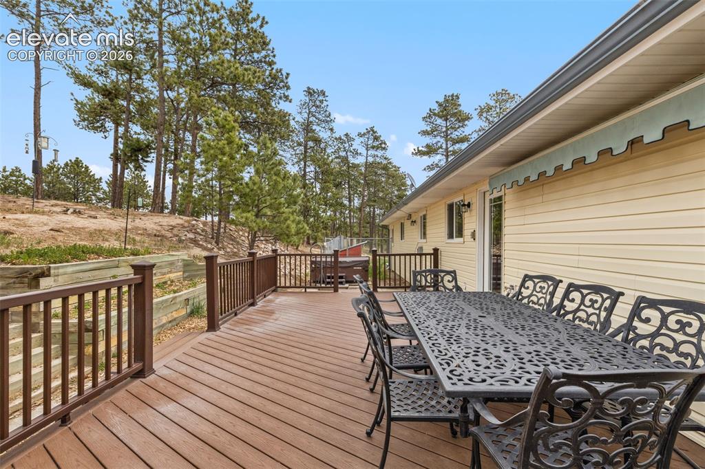 Image 29 of 50: Back deck with easy access up the hill to the coop!