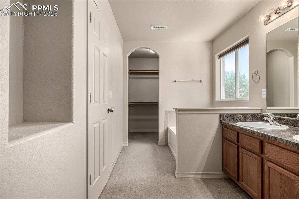 Image 15 of 30: Primary Bathroom and Walk In Closet