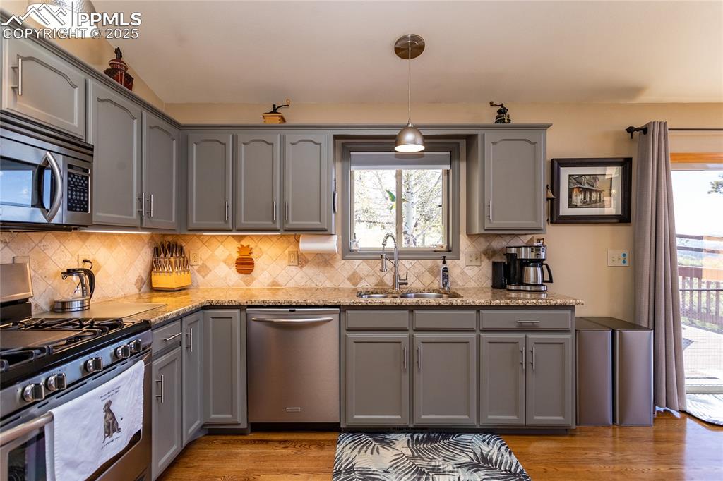Image 14 of 44: Kitchen with stainless steel appliances, double sink, Granite Counters and