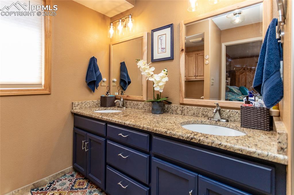 Image 18 of 44: Bathroom with double vanity and radiant in-floor heat