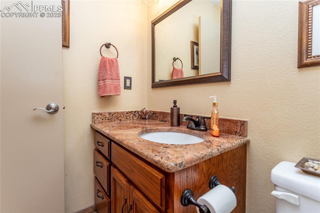 Image 26 of 44: Upper level Bathroom featuring vanity with Granite counter