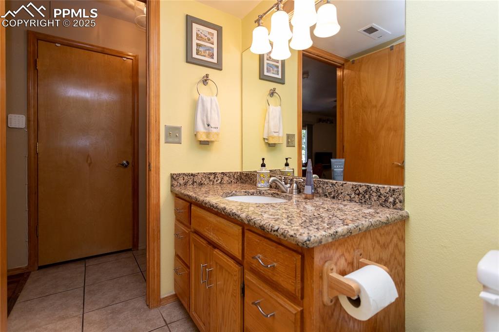 Image 29 of 44: Lower level Bathroom with Granite counter
