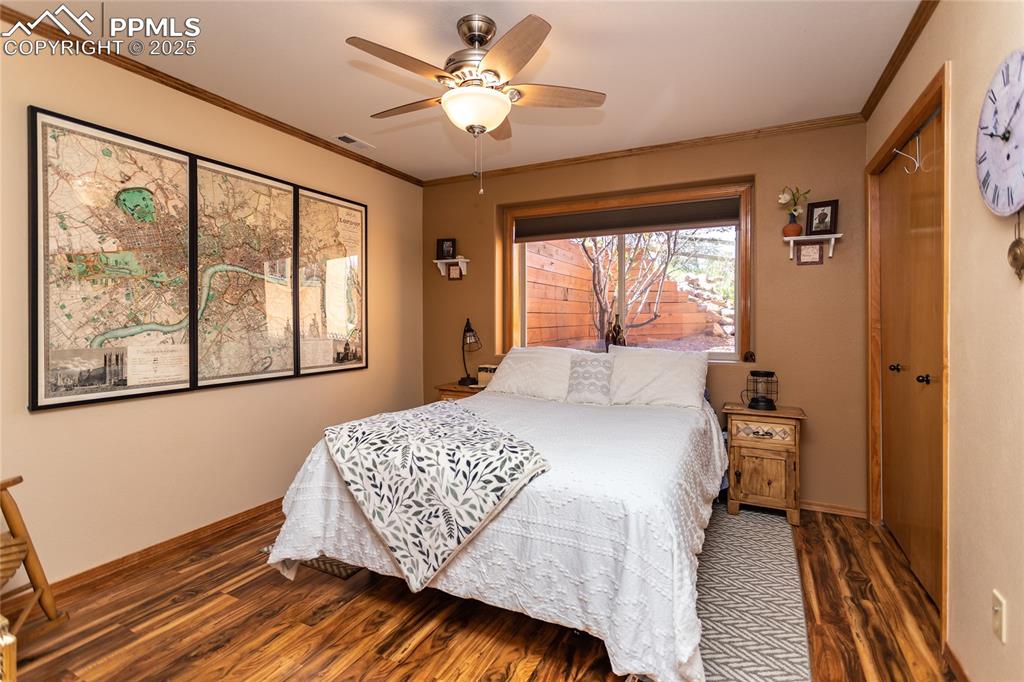 Image 31 of 44: Lower level Bedroom featuring wood finished floors, a ceiling fan, partial