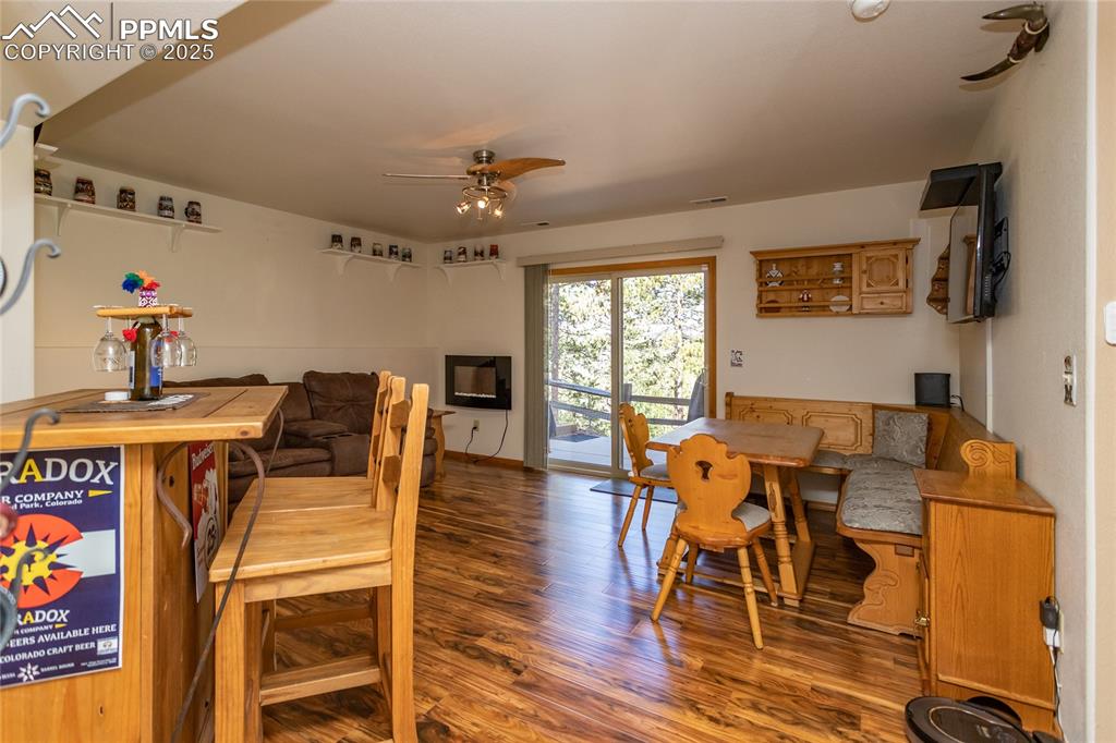 Image 32 of 44: Lower Family room featuring ceiling fan, wood finished floors, Electric fir