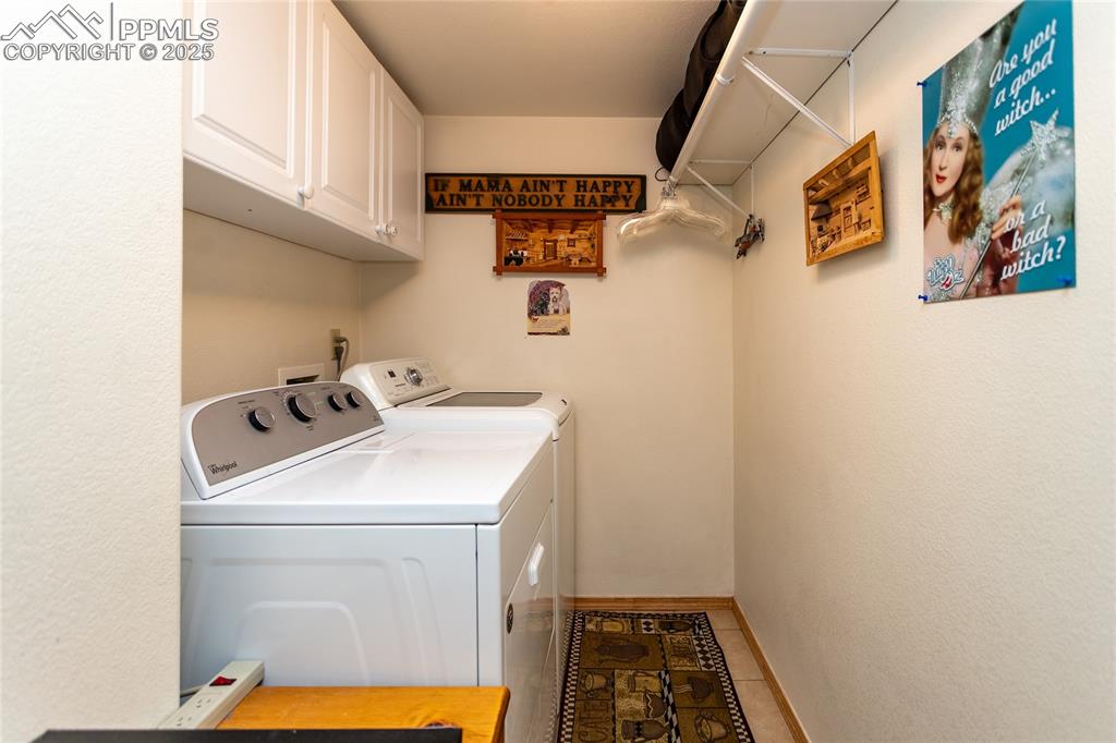 Image 36 of 44: Laundry area with shelving and cabinet space