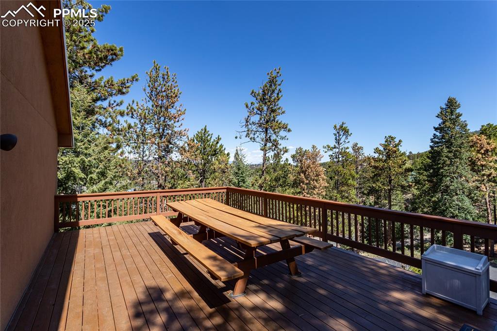 Image 38 of 44: Wooden deck off of primary bedroom with Tarryall views