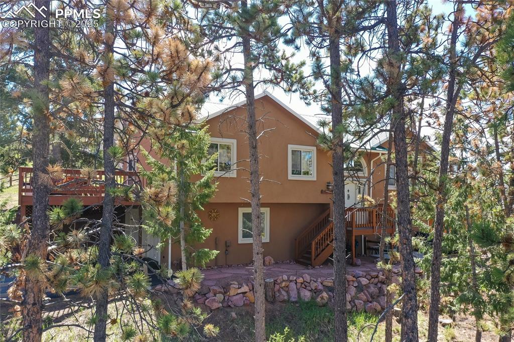 Image 7 of 44: Front view with front entrance, stucco siding
