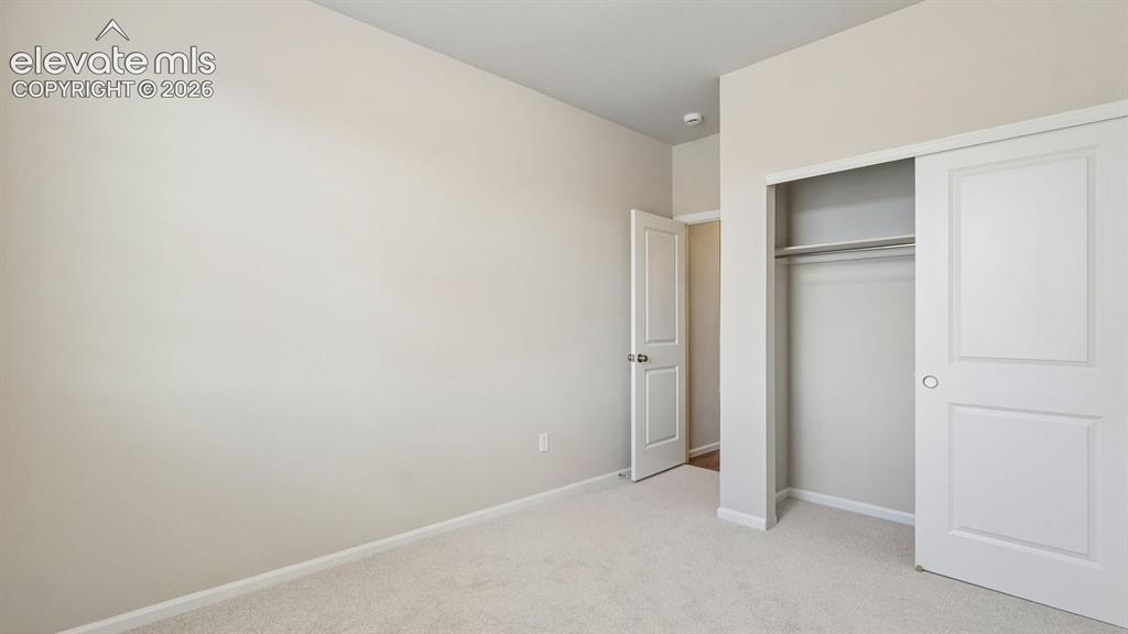 Image 14 of 47: Neutral wall finishes, plush carpeting, white trim, and a spacious closet w