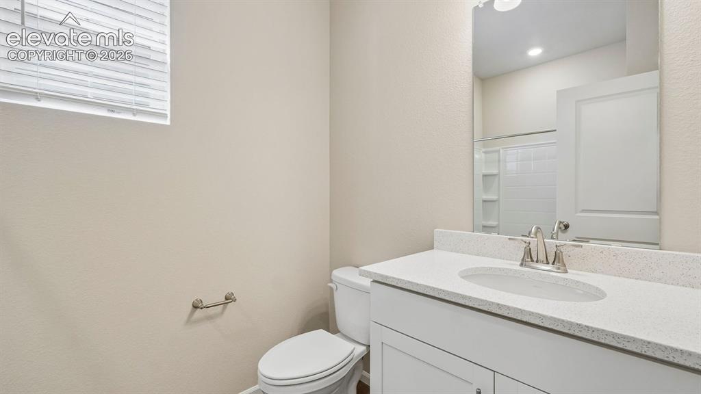 Image 16 of 47: White vanity with an integrated sink, brushed nickel faucet, and a wall-mou
