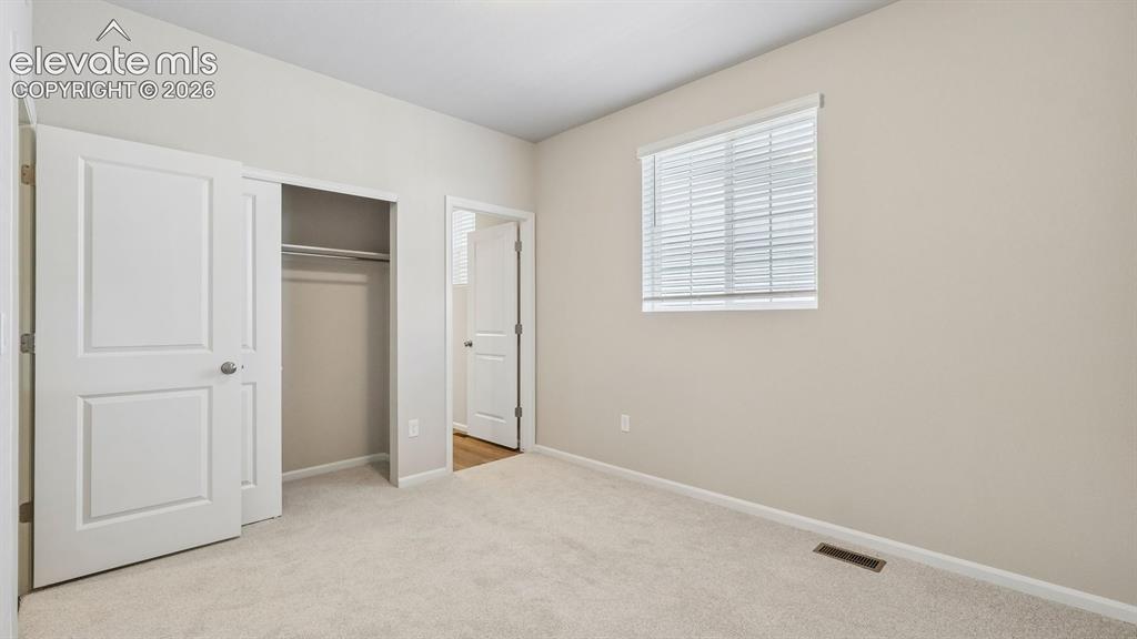 Image 23 of 47: Neutral-toned walls complement the light-colored carpeting