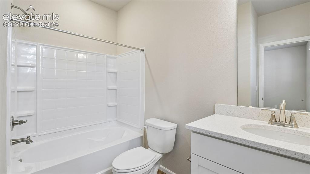 Image 25 of 47: Full-size vanity with a light-toned countertop, integrated sink, and brushe