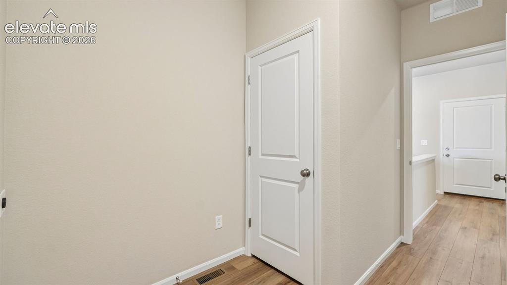 Image 26 of 47: Wood-finish flooring with neutral wall paint and white trim