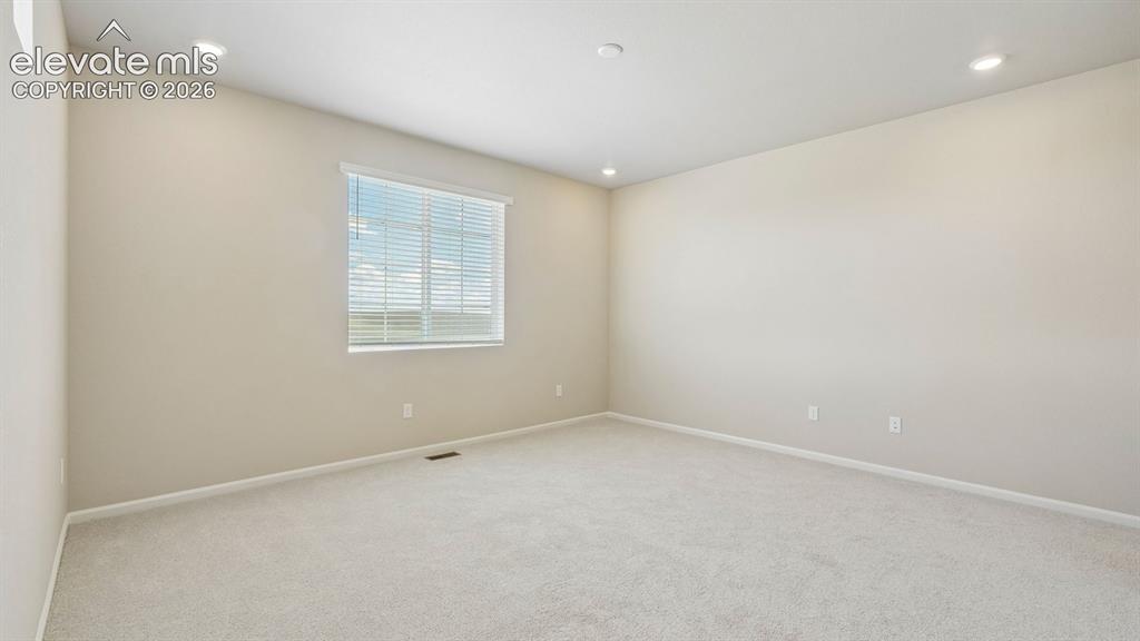 Image 30 of 47: Recessed lighting and a window with horizontal blinds