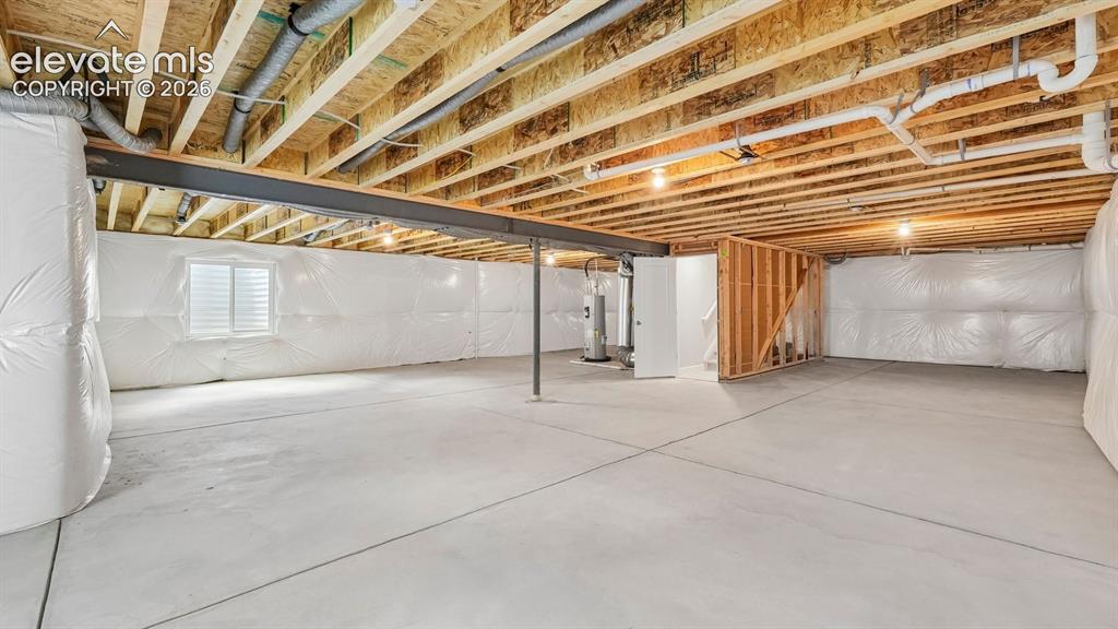 Image 35 of 47: Unfinished basement featuring exposed wood joists, concrete flooring, insul