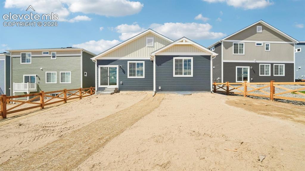 Image 41 of 47: Rear exterior with wood-toned fencing, sliding glass door access, and multi